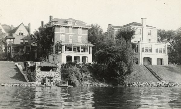 A view of the shore, looking southeast from Lake Mendota.  At left is the Thomas E. Brittingham residence and boathouse, 640 North Henry Street; center is 225 Lakelawn Place, the Alpha Tau Omega fraternity house; and right is 222 Lakelawn Place, the Psi Upsilon fraternity house, built in 1913 and occupied by them from 1918-1972.  The Alpha Tau Omega house was built in 1914, probably for that fraternity.  It later became a privately owned house for women, known as Victoria House.
