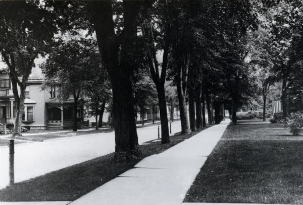 A view looking southwest down the 100 block of Langdon Street.  Visible at left center is Chief Justice John B. Winslow's residence, 131 Langdon. The flag marks Senator John Coit Spooner's residence, 150 Langdon Street.