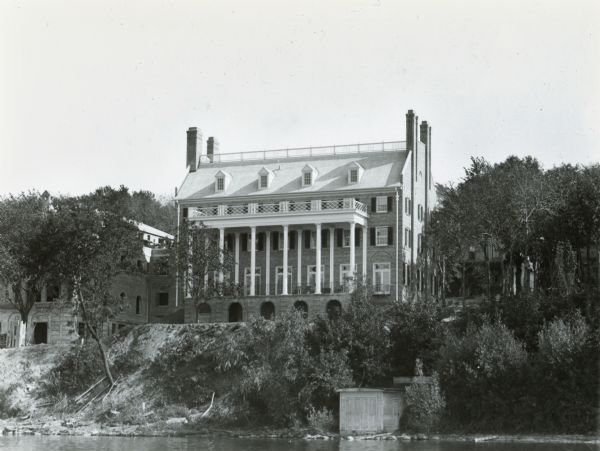 124 Langdon Street, viewed from Lake Mendota.  The house was designed by Madison architect Frank Riley and built in 1924 for the Kappa Sigma fraternity.  The Acacia fraternity house, under construction, is visible at left.