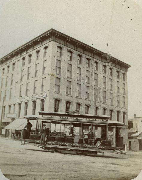 Hotel Madison, on the north corner of Capitol Square with a Madison Traction Company car in the foreground.