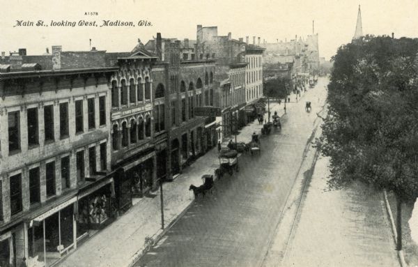 Elevated view on Main Street on the Capitol Square. Caption reads: "Main St., looking West, Madison, Wis."
