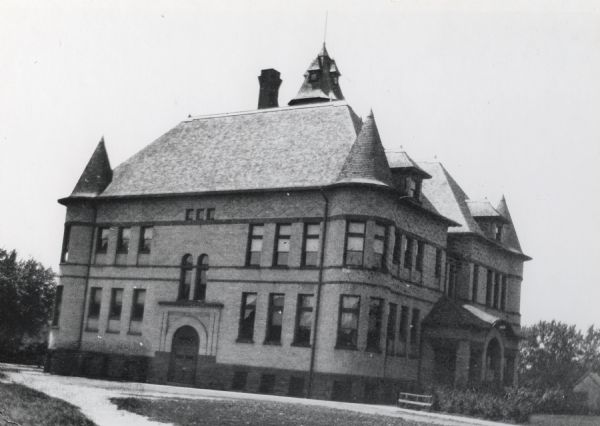 Exterior of the 6th Ward School at 1237 Williamson Street. The building was designed by the Madison firm of Conover and Porter, and featured five turrets, the tallest of which stood nine stories above the ground. It was finished with Ashland brown stone and cream brick. Later renamed Marquette School.  Torn down ca. 1950.