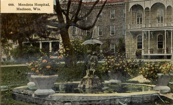 Exterior of the Mendota State Hospital (Mendota Mental Health Institute) with stone fountain in front. Caption reads: "Mendota Hospital, Madison, Wis."