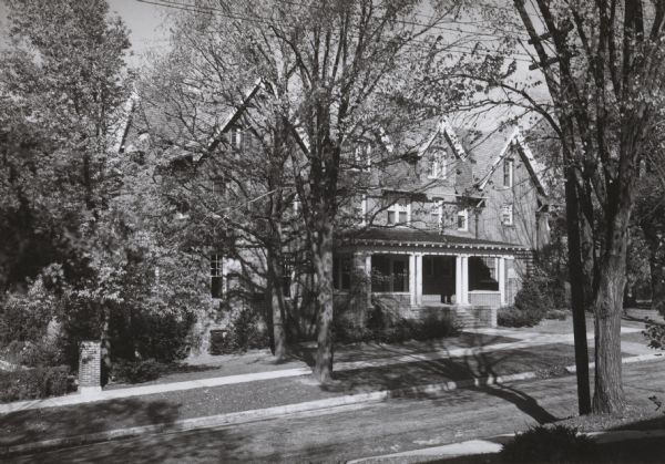 Slightly elevated view across street towards the John M. Olin house, located at 130 N. Prospect. Constructed in 1912 and attributed to the Milwaukee architectural firm of Ferry and Clas. Later, it became the home for the presidents of the University of Wisconsin.