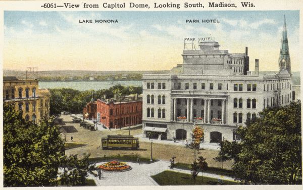 Elevated view of the Park Hotel, looking south from the Capitol Dome. Lake Monona is in the background. A streetcar is in the intersection. Caption reads: "View from Capitol Dome, Looking South, Madison, Wis."