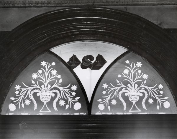 Etched glass windows over the front door at the Pierce house at 424 North Pinckney Street, built about 1857.