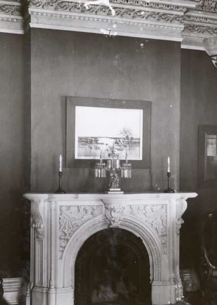 The Pierce House, at 424 North Pinckney Street. This house was built about 1857 and was designed by architects Donnel and Kutzbock. One of the five fireplaces in the house, carved from Carrara marble in complex designs to reflect the mouldings and large, heavy ceiling pieces. Stylized classical motifs, such as the canthus leaf and egg-and-dart, and ninteenth century realism of flowers and fruit are intricately mixed with some early Renaissance forms to create an elaborate effect.