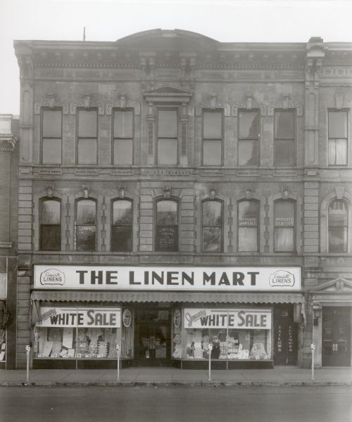 Linen Mart Building, adjacent to the American Exchange Bank, at 3 North Pinckney Street, on the Capitol Square.  A dentist office is located directly above the Linen Mart.