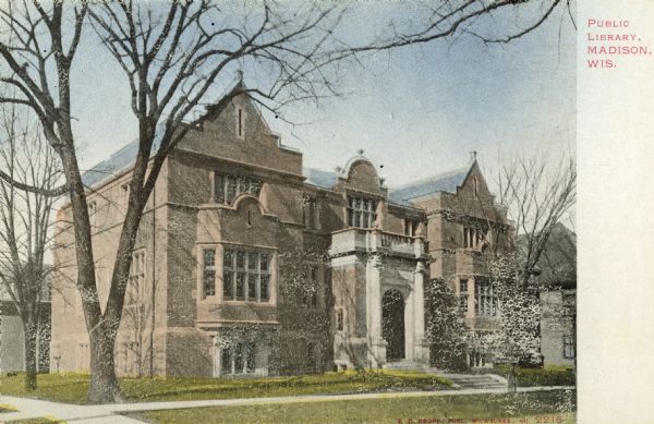 Postcard view of the Madison Free Library and its surrounding area. The library was built with Carnegie money and opened in 1906. The name changed to Madison Public Library in January 1959. This building was torn down in 1965 when the library moved to a new building at 201 West Mifflin Street. Caption reads: "Public Library, Madison, Wis."