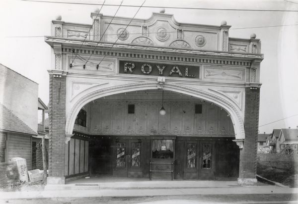 View across street of the exterior of the Royal Theater, 407 Atwood Avenue (address now 2142 Atwood). Designed by Ferdinand Kronenberg (?)  Building remodeled/replaced (1923?) by Universal Grocery, now (2014) site of Wilson's Bar. Houses are in the background on the right.