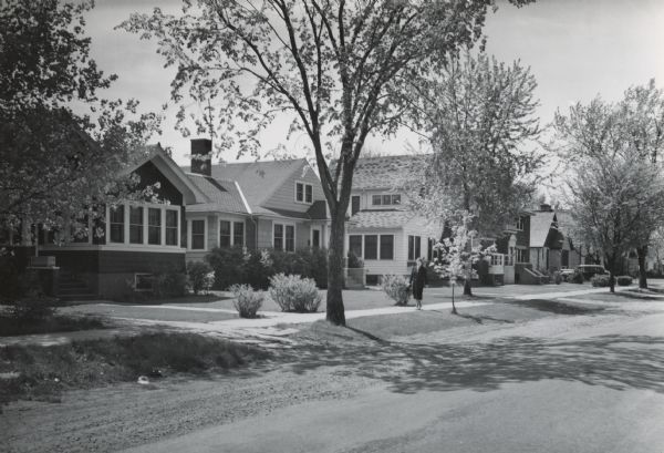 View from street towards the left of the residential neighborhood on Russell Street. The original negative was used for the Works Progress Administration (WPA) Writer's Program Collection as an illustration for the book "Wisconsin: a Guide to the Badger State," 1941 (a WPA compilation).