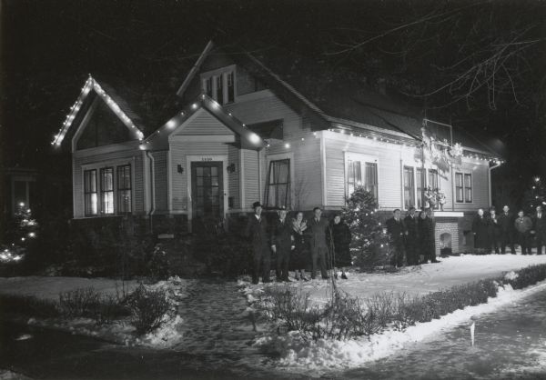 View of a decorated house at 1450 Rutledge Street. There are individuals gathered on the lawn.