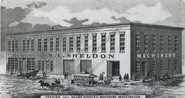 Slightly elevated view of the S.L Sheldon Company Warehouse and Office. Outside of the building, there is a bustling street filled with pedestrians and horse-drawn vehicles. This print is from the cover of their machinery catalog, filed in the Historical Library's pamphlet collection.