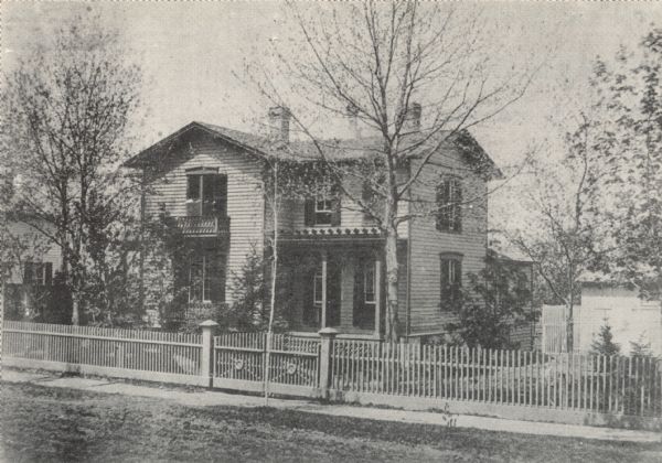 View of the Stephen Vaughn Shipman house at 65 Spaight Street, near the intersection of Ingersoll Street. The house was designed and built between 1855 and 1858 by Shipman, an early Madison architect. A fence surrounds the residence and there are numerous trees in the yard.