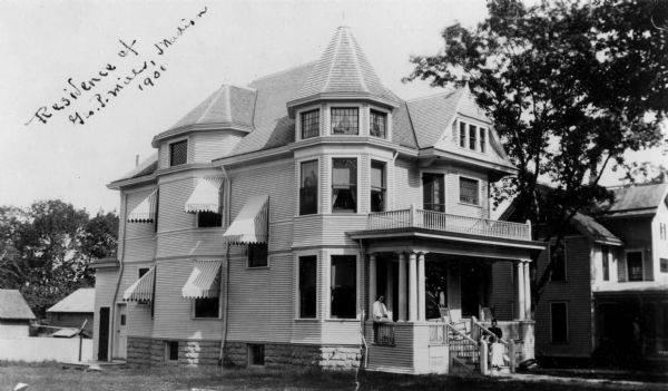 View of the George P. and Annie L. Miller residence at 1030 Spaight Street. Several members of the Miller family are resting on the front porch.