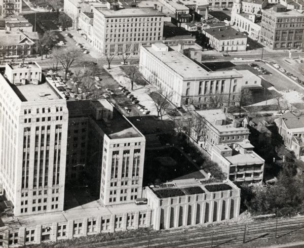 An aerial view of the State Office Building, 1 West Wilson Street. Also shows Olin Terrace, Madison Club and the United States Post Office.