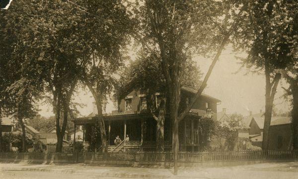 View of the L.F. Kellogg houses at the intersection of State and Dayton Streets. On the porch are Julia Kellogg and "Grandma" Adams.