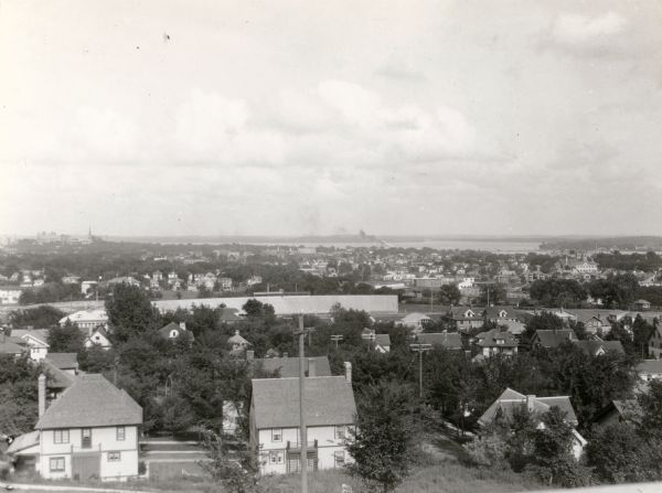 Elevated view looking east towards the Wisconsin State Capitol and Lake Monona from the University Heights neighborhood. Camp Randall stadium is just beyond the houses in the foreground.