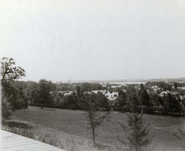 View of Lake Monona from Observatory Hill, on the University of Wisconsin campus. Building are below the hill among trees.