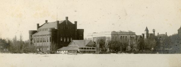 View of the lower University of Wisconsin campus from a frozen Lake Mendota. The Armory (Red Gym or Old Red), boathouse, The State Historical Society, Music Hall, and Science Hall are visible.