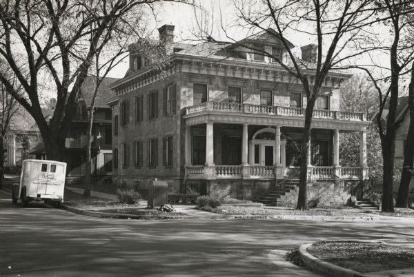 An exterior view of the Levi B. and Ester Smilie Vilas residence, located at 521 North Henry Street, at the intersection of Henry and Langdon Streets. Built in 1851 at at cost of $15,000, its location on Lake Mendota ridge was considered to be remote because of its distance north of the Capitol. Vilas died in 1878 and his wife continued to reside in the house until her death in 1892. From 1911 to 1927, the house served as the Phi Gamma Delta fraternity house for the University of Wisconsin. In 1965, the house was demolished to enable the construction of the current Evans Scholars House.