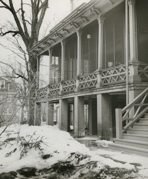 Porch on the Vilas house, 12 East Gilman Street, which later became the College Women's Club. The house was built in 1860 by Julian (or Julius) Clark, an Englishman, and bought in 1877 by William F. Vilas, who added two large wings in 1901-1902. The owner in 1951 was a member of the Vilas family, Mrs. Louie M. Hanks.