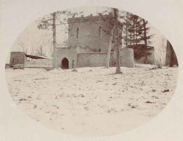 A view of the rear entrance to the Benjamin Walker castle (ca. 1862-1893) and its surrounding backyard, 900 block East Gorham Street.