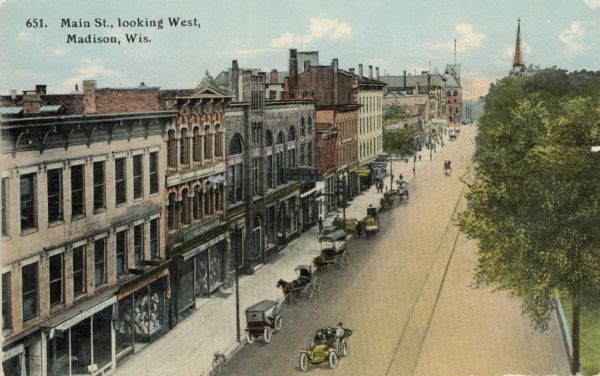 Elevated view of Main Street on the Capitol Square. Caption reads: "Main St., looking West, Madison, Wis."