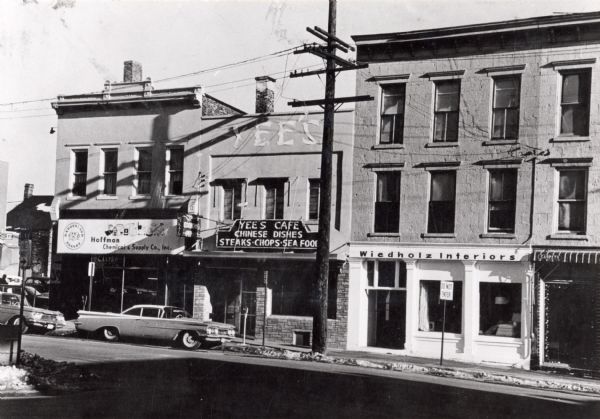 View of the 100 block of Webster Street. Buildings include Hoffman Chemical and Supply Company at 117 South Webster, Yee's Cafe at 199 South Webster and Wiedholz Interiors at 121 South Webster.