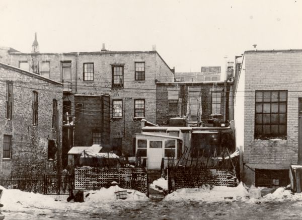 View looking south at the rear of buildings on the 100 block of Webster Street. Wiedholz Interiors, at 121 South Webster Street, (building left of center), along with Yee's Cafe, 119 South Webster at center, and Hoffman Chemical and Supply Company, 117 South Webster, at right.