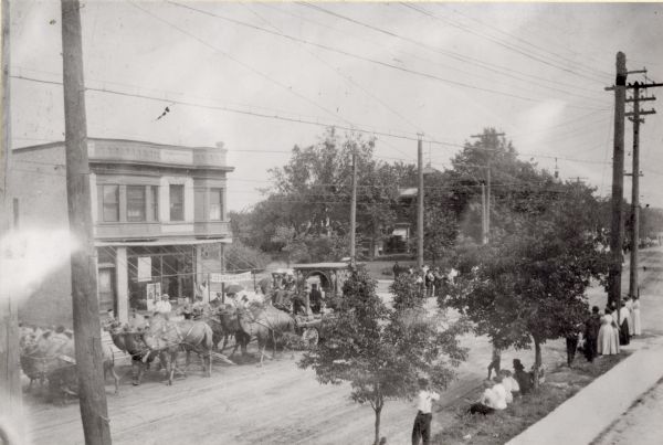 Circus parade passing Frederick and Mary Mark's confectionary. This view is north-northeast beyond the intersection of Williamson and Dickenson Streets.