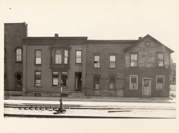 631-635 East Wilson Street. The far right building is an office for Roy's Transfer and Storage Company.