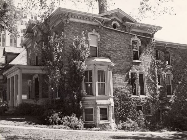 Side view of a large, brick house, located at 109 West Wilson Street.