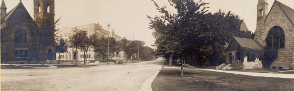 Panoramic view looking north down the tree-lined 100 block of Wisconsin Avenue, with Christ Presbyterian Church and Central High School (later Madison Area Technical College) on the left and the Unitarian Society Meeting House on the right side.