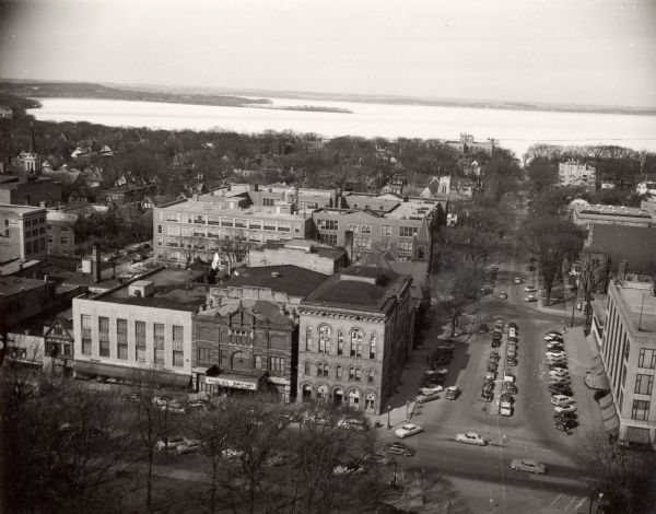 Looking northwest down Wisconsin Avenue from the Wisconsin State Capitol dome. Mifflin Street is visible in the foreground, while in the center of the photograph, the former City hall building is present, which was demolished starting on August 31, 1954.