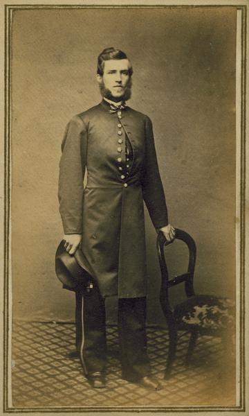 Full-length carte-de-visite portrait of Horace Moore of Richfield, Wisconsin, a member of the 1st Brigade, 3rd Division, 15th Army Corps Band. Discharged July 2nd, 1864.