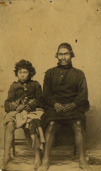 Cedakumin, chief of the Clyaquot Indians, seated next to his son, Benjamin.