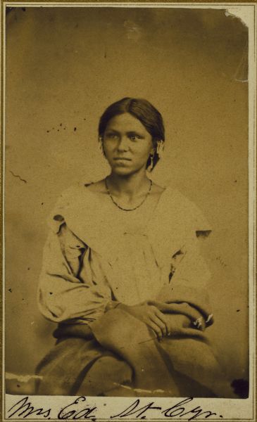 Portrait of Mrs. Ed St. Cyr (He-no-nee-kaw), of the Sioux tribe.  The text on the back reads:  "Mrs. Ed. St. Cyr.  She died about two years ago.  I helped dig her grave.  Her first husband was Little Priest, and she was the only woman on the scouting expedition of which he was the leader.  Her Indian name was He-no-nee-kaw (eldest daughter)." 
-- Oliver Lemere, 1926.