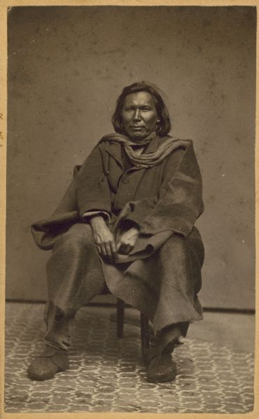 Seated portrait of an unidentified Native American man.
