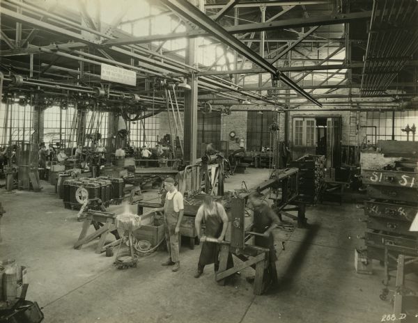 Factory workers construct frames in the Frame Assembly Department of the Winther Motor and Truck Company.