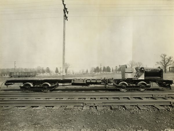 Gasoline rail car manufactured by the Winther Motor and Truck Company, situated on railroad tracks.