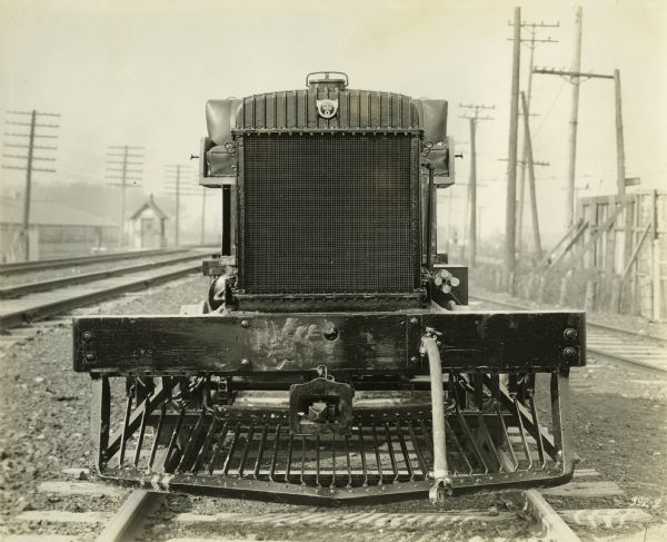 Front view of gasoline rail car manufactured by the Winther Motor and Truck Company, situated on railroad tracks.