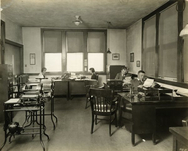 Workers in the Sales Department of Winther Motor Company. Included are Mr. H.P. Lundskow, Mr. Harry Schneider and two female workers.