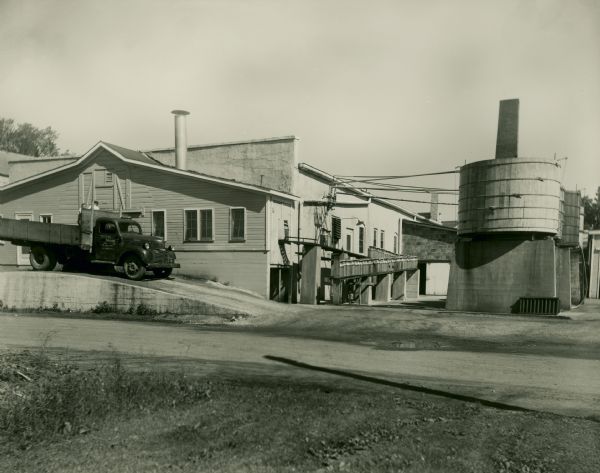 Exterior of the Brodhead Cheese Factory with a truck in front.