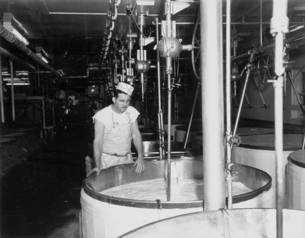 Kenneth Clark watches milk go into a kettle at the Brodhead Cheese Factory.