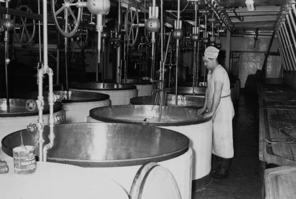 Kenneth Clark filling kettles at the Brodhead Cheese Factory.