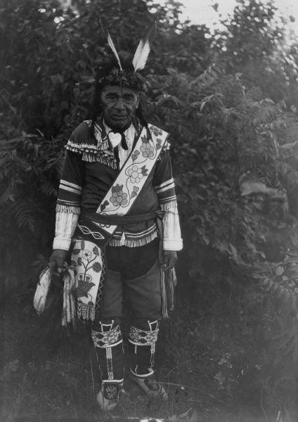 Ami Kons (Young Beaver), an Ojibwa warrior. His two feathers means he has taken two Sioux scalps.