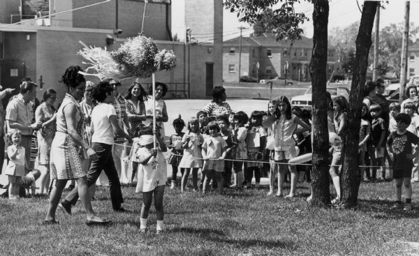 Children attempt to break a pinata at a Sunday picnic at Our Lady of Lourdes Catholic Church.