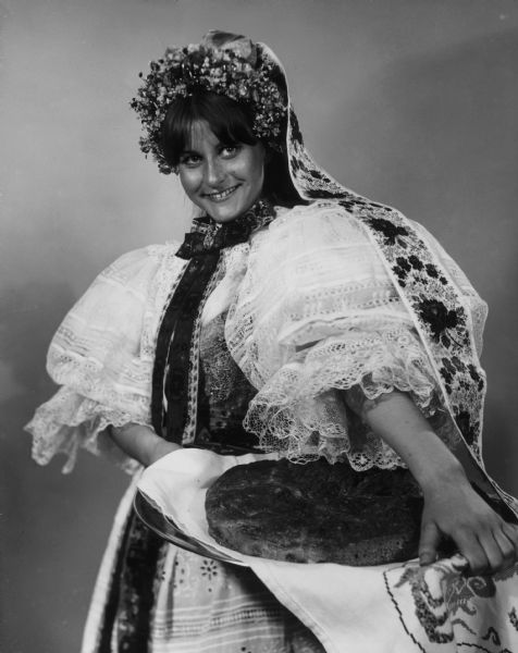 Miss Jacqueline Alice Biksadski, 17, representing Milwaukee Slovaks at the annual Folk Fair, wearing a traditional Slovak dress and carrying a loaf of bread baked by her grandmother.