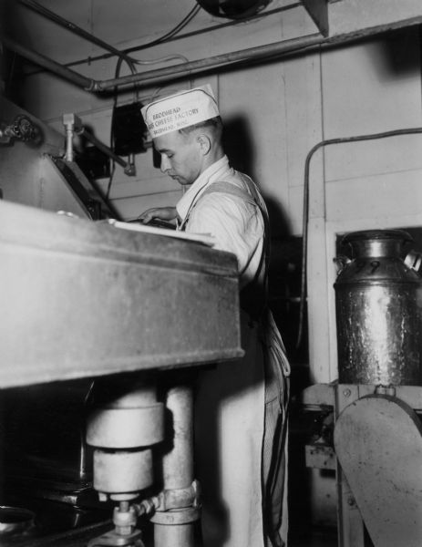 Fritz Friedly Dumping Milk | Photograph | Wisconsin Historical Society